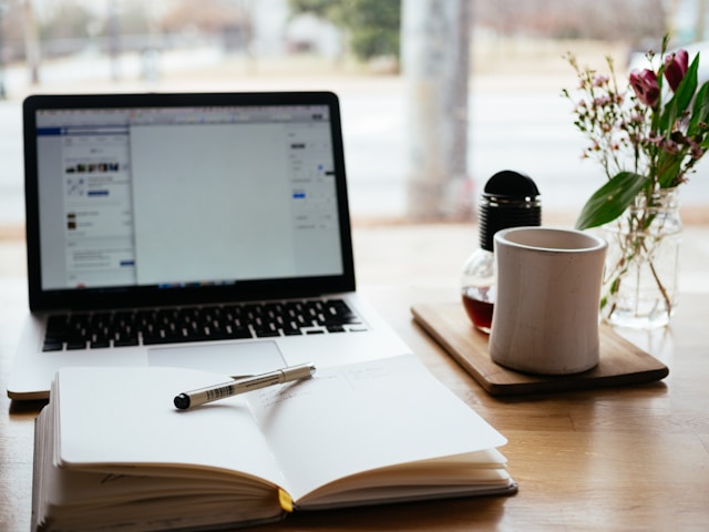 Laptop and book illustrating The Financial Planning Process
