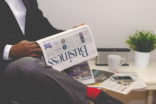 Man holding a newspaper, symbolizing financial planning
